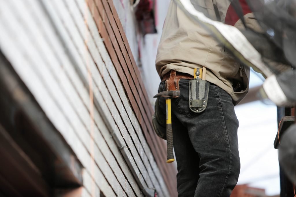 Canva - Man Wearing Black Denim Pants With Carrying Hammer on Holster