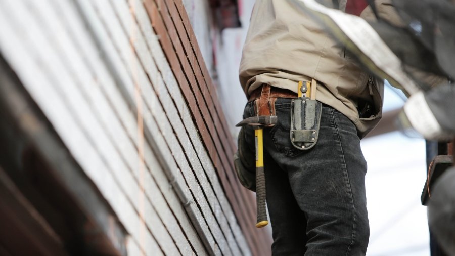 Canva - Man Wearing Black Denim Pants With Carrying Hammer on Holster